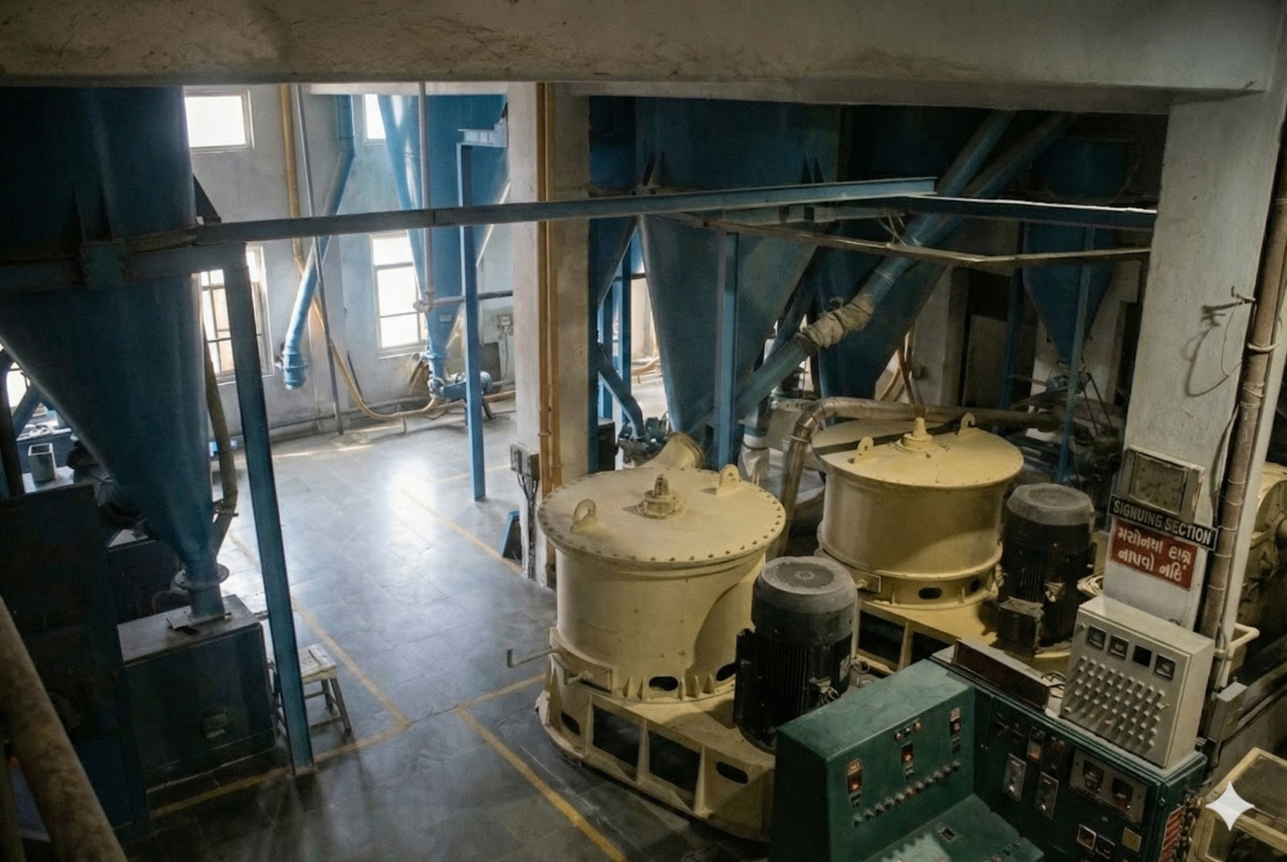 B.D. Guar Pvt. Ltd. pulverizing section - Industrial Guar Gum grinding mills with blue pneumatic cyclones and control panels in Kalol, Gujarat